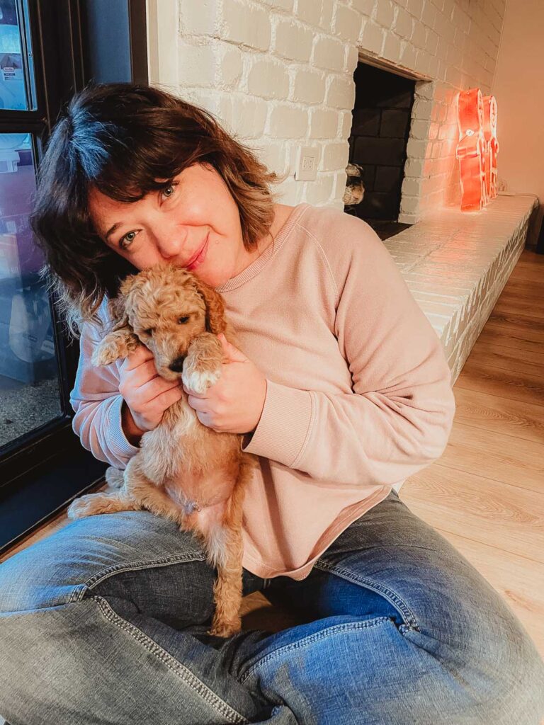 Poodle being hugged by Desiree